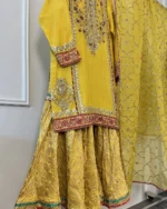 Close-up of mustard yellow organza dupatta with gold sequin jaal trellis pattern and silver mirror star motifs — Pakistani bridal dupatta