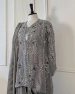 Close-up detail of grey organza bridal kurti showing multi-strand pearl bead chain drape, silver sequins, 3D navy floral appliqué and zardozi leaf motifs