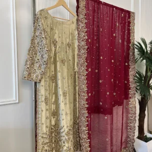 Full view of 3-piece gold and maroon Pakistani bridal suit on clothing rack showing embroidered kurti, heavy sleeve embroidery and maroon dupatta with gold border