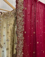 Close-up detail of gold tissue bridal kurti neckline with zardozi embroidery and maroon dupatta with wide gold zardozi scalloped border