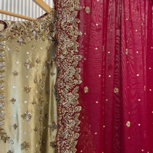 Close-up detail of gold tissue bridal kurti neckline with zardozi embroidery and maroon dupatta with wide gold zardozi scalloped border